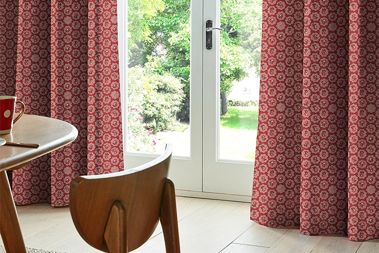 Room with red geometric flower design roman blind from Cath Kidston