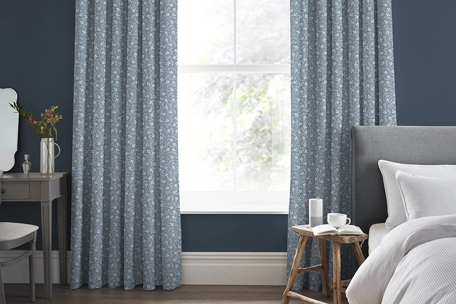 Bedroom with blue floral curtains from Laura Ashley