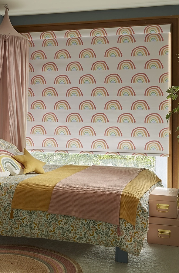 Room with rainbow design roller blind with matching cassette from illumin8 Simply™ Roller Collection