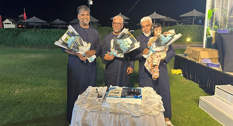 Owners of illumin8 cutting cake for 25 years of the business