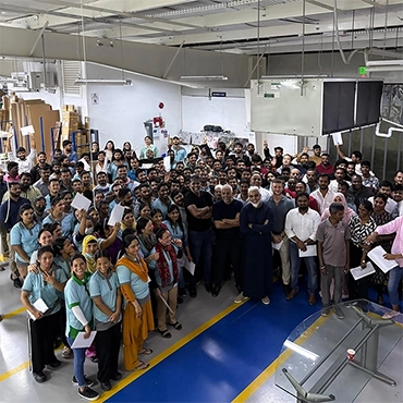 illumin8 factory workers celebrating anniversary of the business